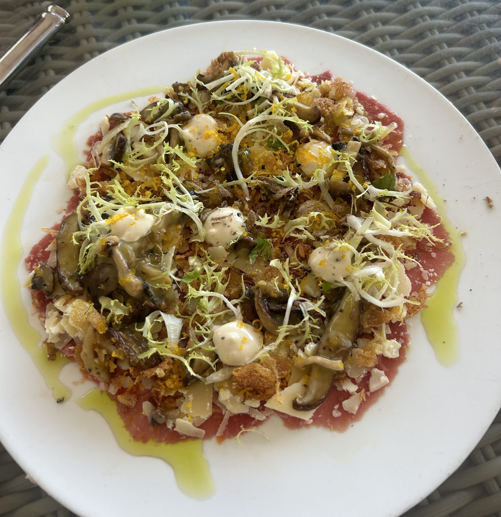 Beef carpaccio with mushrooms and frisée by private chef Andrew Oliver
